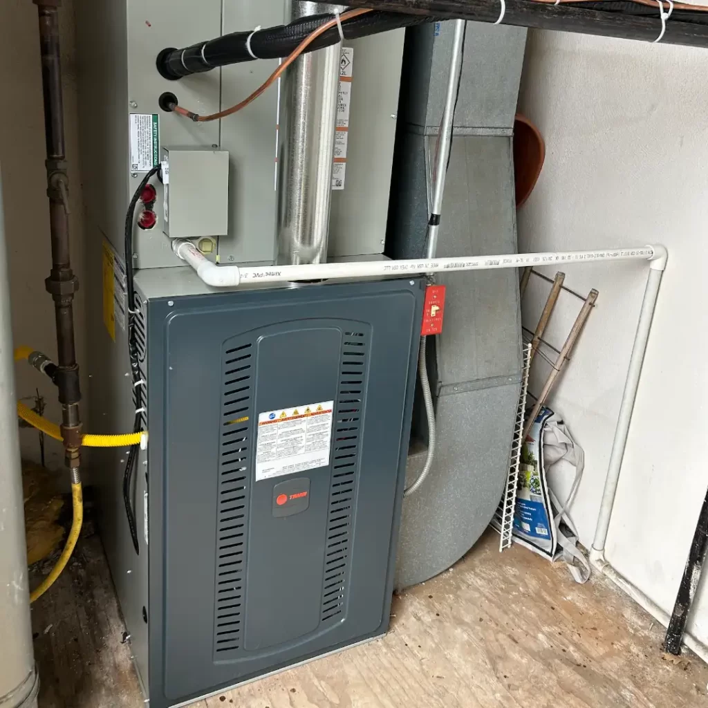 Professional heating system installation showing a modern gas furnace connected to existing ductwork in Rhode Island