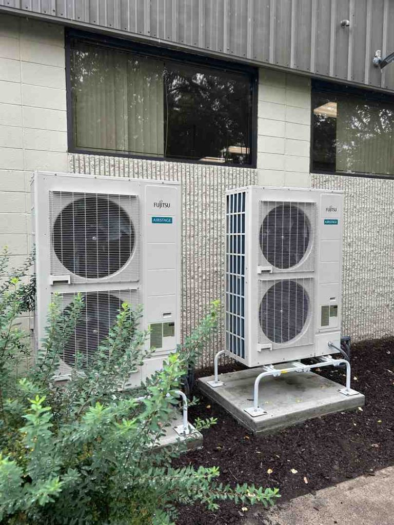 commercial heating and cooling maintenance technician servicing rooftop unit - commercial heating and cooling maintenance